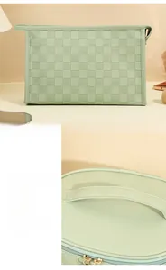 Detail of mint green woven texture makeup bag with sturdy handle and gold zipper