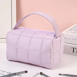 Quilted lavender nylon cosmetic bag with top handle and zipper for travel storage
