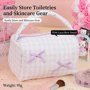 Light purple quilted cosmetic bag with lavender bows and delicate lace trim detail
