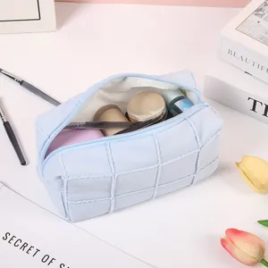 Quilted light blue macaron makeup bag with zipper showing spacious storage for cosmetics