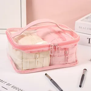 Portable waterproof transparent makeup bag set with pink handles and internal pouches
