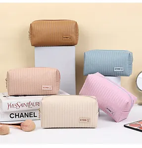 Quilted PU leather cosmetic bags in various colors with gold zipper and woven logo