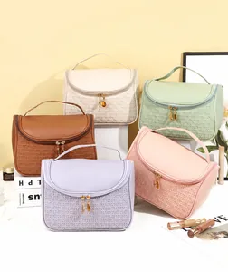 Detailed view of portable PU leather cosmetic bags in various pastel colors with metal zippers