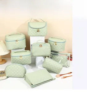 Close-up of mint green checkered makeup bags with decorative golden cat zipper pullers