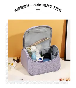 Open purple PU leather makeup bag showing internal mesh pocket and large storage space