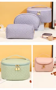 Detail view of woven texture PU leather makeup bags in purple, green, and pink colors