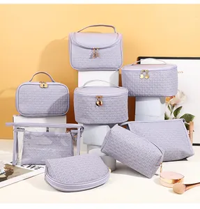 Detailed set of 7 lavender PU leather makeup bags with woven texture and gold zippers