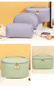 Close-up of woven texture and gold metal zipper on lavender checkered travel toiletry bag