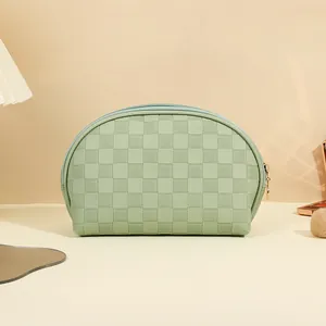 Mint green semi-circle PU cosmetic bag with checkered texture and golden zipper