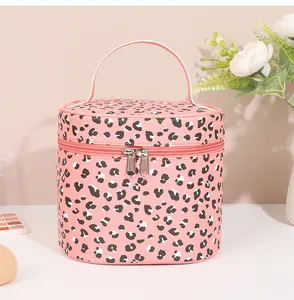 Detail of pink leopard print PU leather makeup bag showing top handle and double zippers