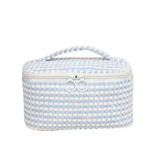Blue and white checkered plush makeup bag with double zippers and top handle