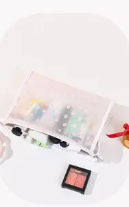 Detail of floral mesh toiletry bag showing its large capacity and zipper closure