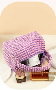 Macro shot of large-capacity checkered makeup bag showing detailed bubble texture fabric