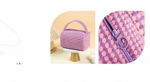 Close-up of pink and purple textured knit fabric and metal zipper on makeup bag