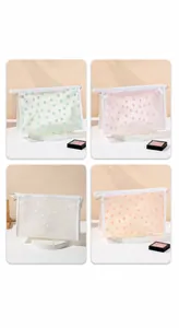 Mesh makeup bag with flocked floral patterns and top zipper in four assorted colors
