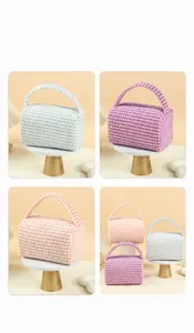 Macro view of woven textured makeup bags in pastel blue and pink with handle detail