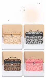 Detail view of four large capacity makeup bags in beige, grey, brown and pink with handles