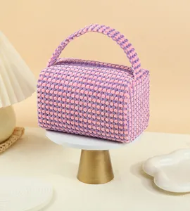 Detail view of pink and purple checkered makeup bag with soft bubble textured fabric