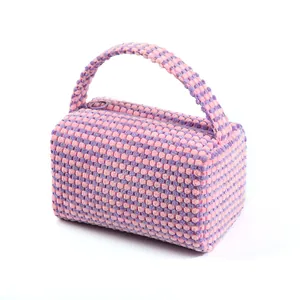 Plaid knitted pillow-style makeup bag in pink and lavender with a top handle