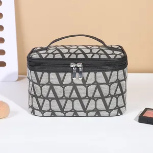 Large gray travel cosmetic bag with black V-pattern print and double zipper closure