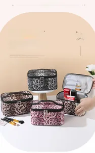 Detailed interior of leopard print makeup bags showing brush slots and large storage