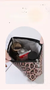 Detailed view of leopard print cosmetic bag showing large interior storage and zipper