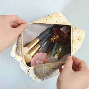 Large capacity floral makeup bag with wide opening showing spacious interior storage