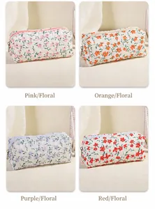 Detail view of quilted floral cosmetic bags in pink, orange, purple, and red patterns