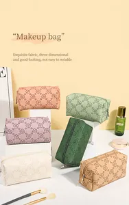 Close-up of embossed floral PU leather makeup bags in multiple colors and textures