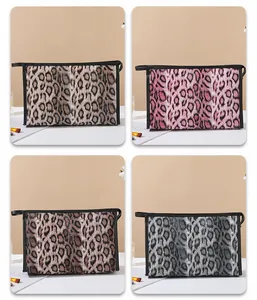Detailed view of four leopard print cosmetic bags in brown, pink, coffee, and grey