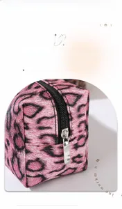 Close-up of pink leopard print fabric texture and durable silver zipper on the makeup bag