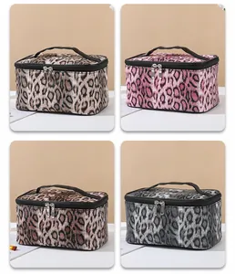 Detail view of four colors of leopard print makeup bags with metallic zippers and top handles
