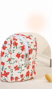 Detail shot of smooth white zipper and floral cotton fabric on the cosmetic bag