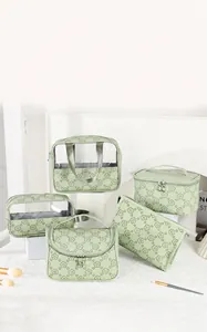 Five-piece set of floral green travel cosmetic bags with clear windows and handles