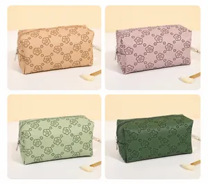 Detail of four floral PU leather makeup bags in khaki lilac milk green and dark green