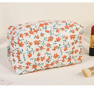 Detail of floral makeup bag with quilted fabric and silver zipper closure for travel