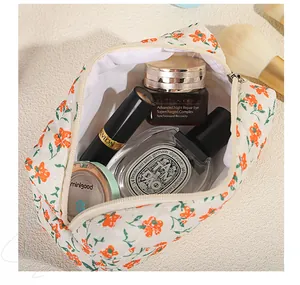Detail view of floral quilted makeup bag with interior space for cosmetics and toiletries