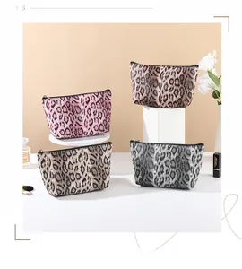 Macro shot of stylish leopard print cosmetic bags in various colors with black zip closure