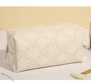 Close-up of floral print PU makeup bag with cream zipper and metallic puller