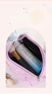 Close-up of quilted lavender makeup bag with wide opening showing spacious interior