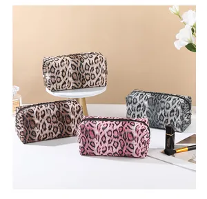 Leopard print makeup bags in four colors with soft fabric texture and sturdy zipper closure