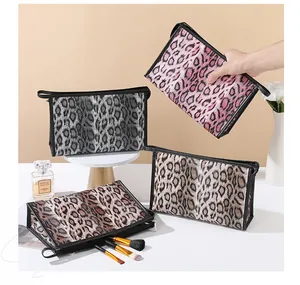 Detail of leopard print makeup bags with zipper closure and portable side handle