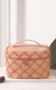 Detail of vintage embossed PU leather makeup bag with pink floral pattern and top handle