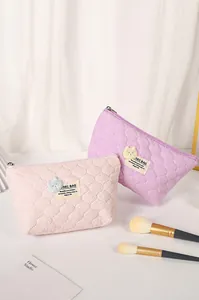 Quilted cosmetic bags in pink and purple with 3D teddy bear patches and zipper closure