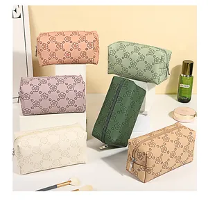 Flat lay of vintage floral PU makeup bags in six diverse pastel colors on white blocks