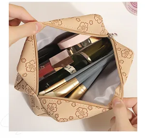 Macro shot of large-capacity beige PU leather cosmetic bag with vintage floral prints