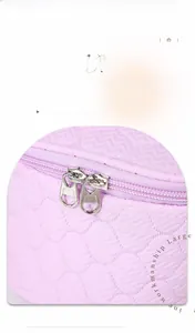 Detail of lavender quilted makeup bag showing high-quality gold dual zipper closures