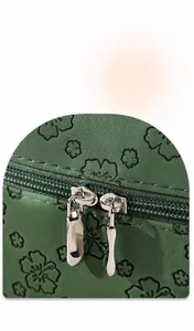 Close-up of green embossed leather makeup bag with durable dual metal zippers