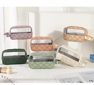 Close-up of vintage PU leather makeup bags with clear windows and floral embossing