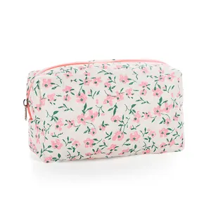 Floral quilted makeup bag with pink flowers and light beige fabric for travel storage